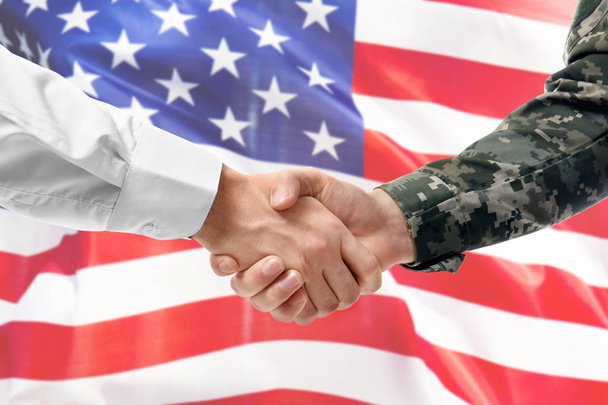 Soldier and civilian shaking hands on USA flag background - Фото, изображение