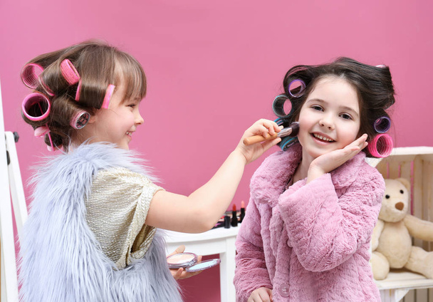 Cute little girls playing with their mother's stuff at home - Foto, imagen