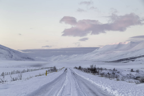 Road in Iceland covered with snow in the countryside, snow on the ground - Фото, зображення