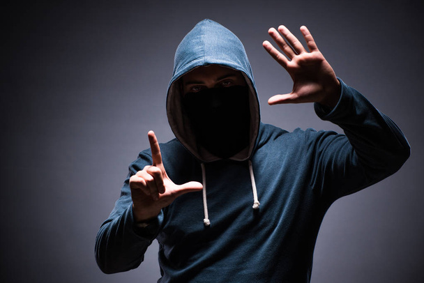 Man wearing hood in dark room - Zdjęcie, obraz