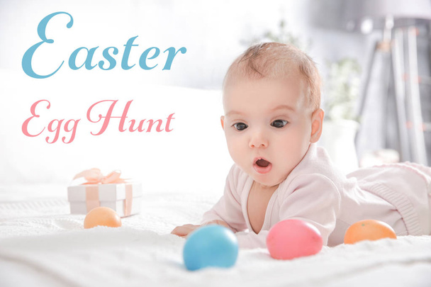 Easter hunt concept. Baby with eggs lying on bed at home - Foto, Imagen