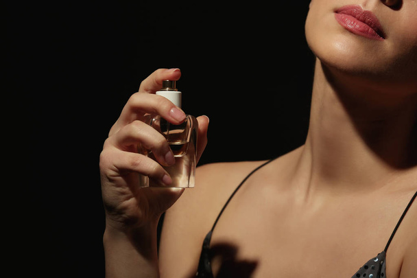 Beautiful young woman with bottle of perfume  - Φωτογραφία, εικόνα