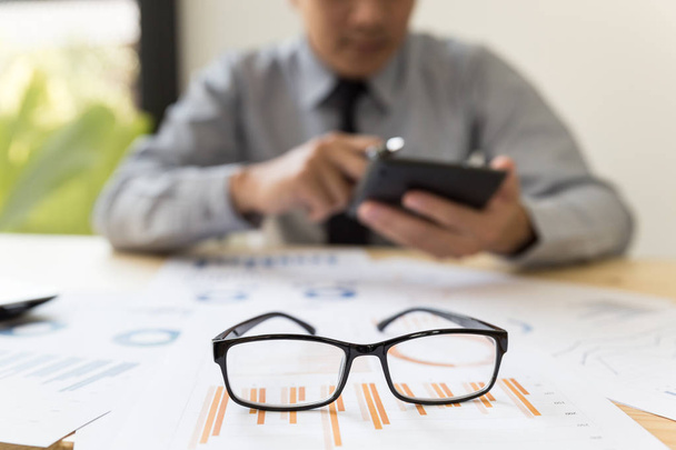 brýle na stole s podnikatelem analýza zpráva na grafu wi - Fotografie, Obrázek