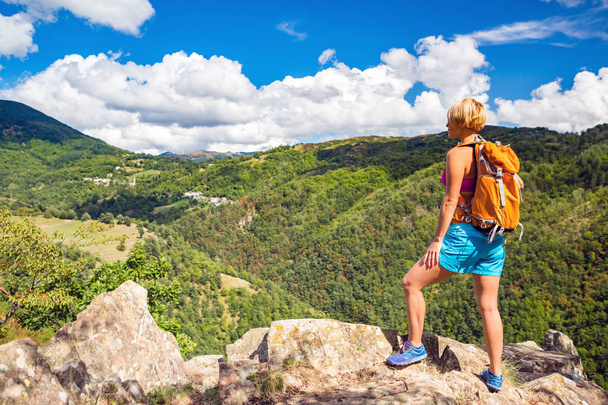 Hiking woman looking at inspirational mountains landscape - Photo, Image