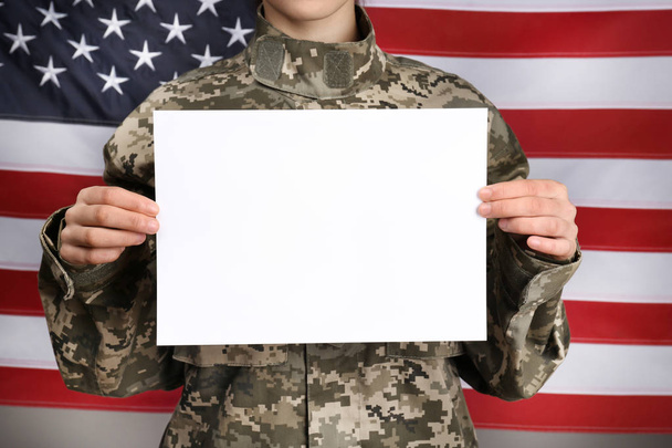 Female soldier with blank poster on flag background, closeup - Φωτογραφία, εικόνα