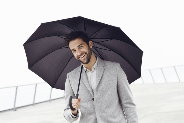 Happy guy with umbrella - 写真・画像