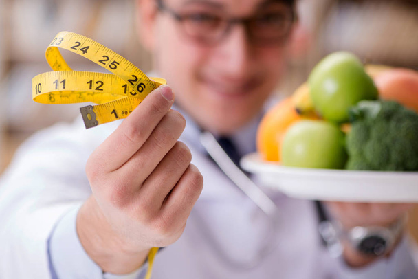 Doctor in dieting concept with fruits and vegetables - Photo, Image