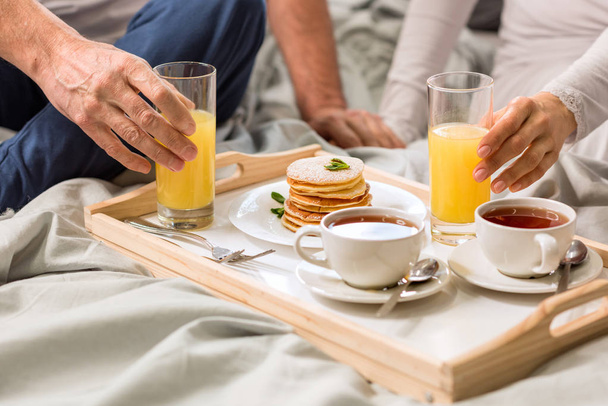 Couple having breakfast in bed  - Fotografie, Obrázek
