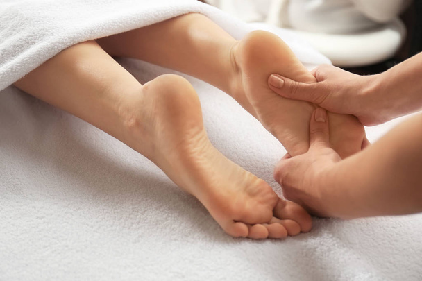 Young woman receiving foot massage - Fotó, kép