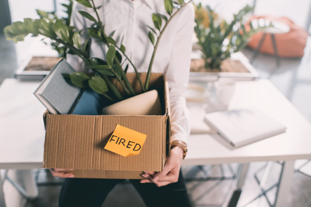 Fired businesswoman holding box  - Photo, Image