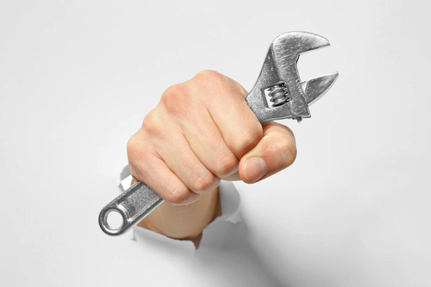 Hand of auto mechanic with wrench   - Foto, afbeelding