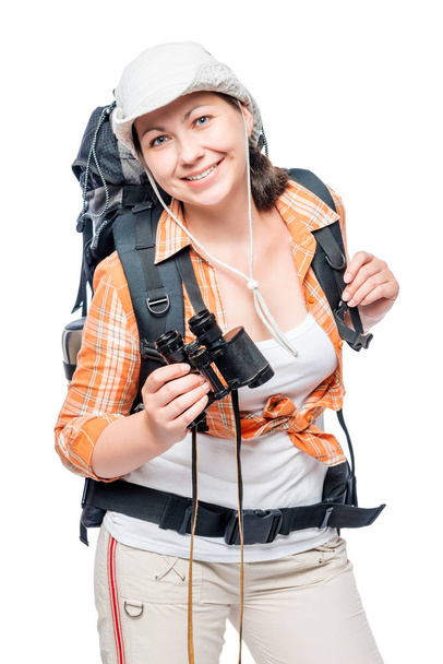 Beautiful young woman hiking with a backpack and binoculars posi - Fotó, kép