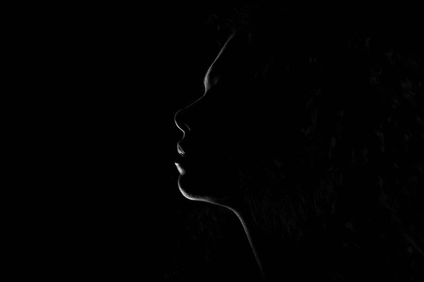 silhouette of a girl on a black background - Zdjęcie, obraz
