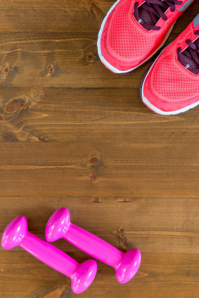 pink sneakers and a dumbbell in the corners of the frame on the  - Fotoğraf, Görsel