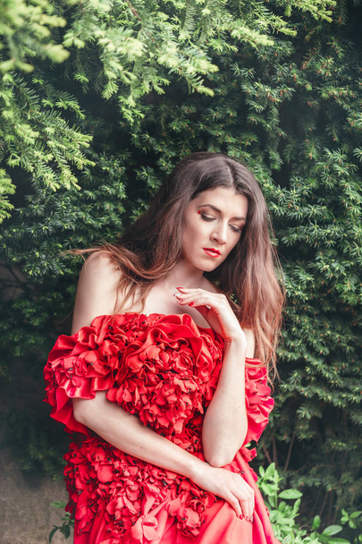 beautiful young woman in red dress - Fotó, kép