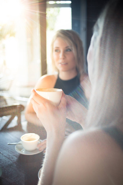 young girlfriends enjoying a cup of coffee  - Φωτογραφία, εικόνα