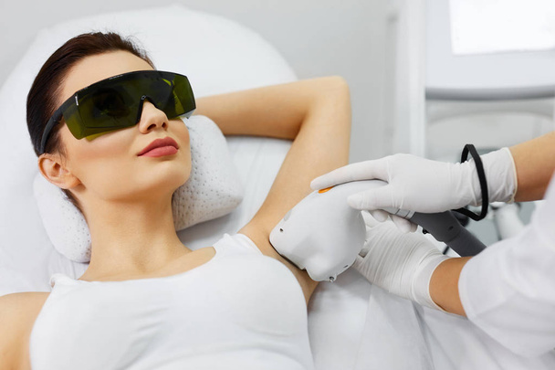 Beautician Doing Laser Hair Removal Treatment On Armpits - Valokuva, kuva