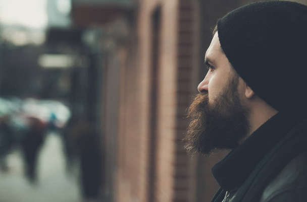 bearded man hipster with serious face in leather jacket - Foto, Bild
