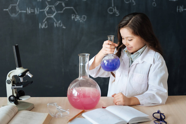 girl taking part in chemistry experiment  - Фото, зображення