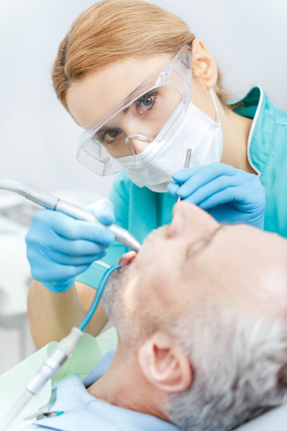 Dentist and patient in clinic  - Foto, afbeelding