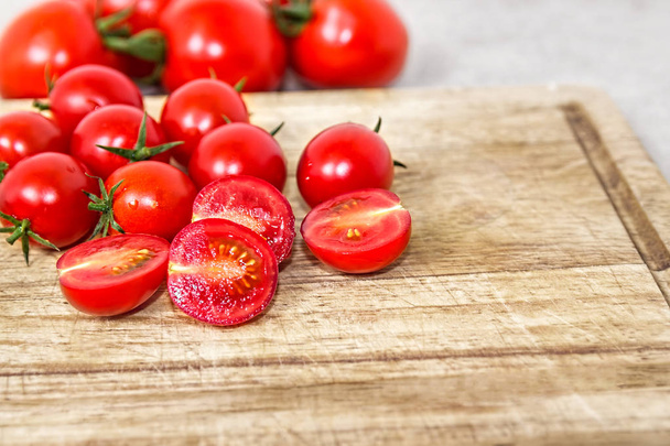 Cherry tomatoes on a wooden cutting board. Vegetable background. Bio products. - Foto, Imagen