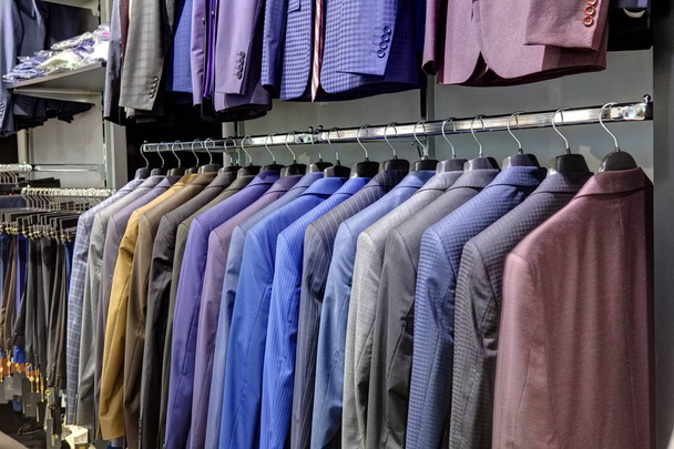 Row of mens suits hanging in closet. - Foto, Imagen