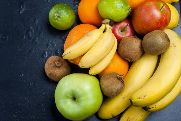 Many various fruits on a black background - Foto, immagini