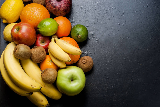 Many various fruits on a black background - 写真・画像