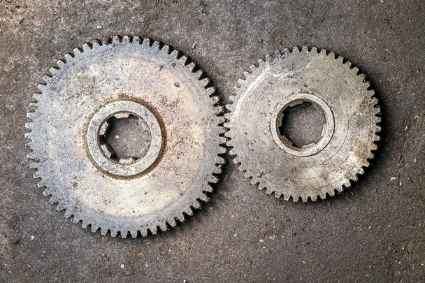 Old rusty gears on the floor - 写真・画像