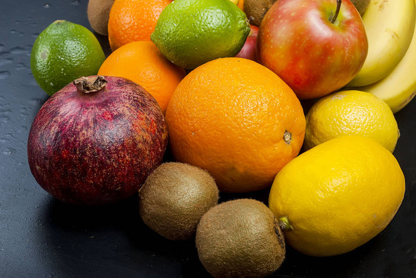 Many various fruits on a black background - Foto, imagen