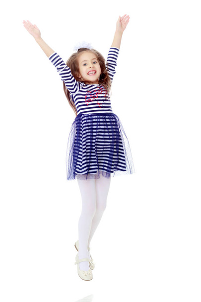Little girl in a striped dress. - Fotoğraf, Görsel