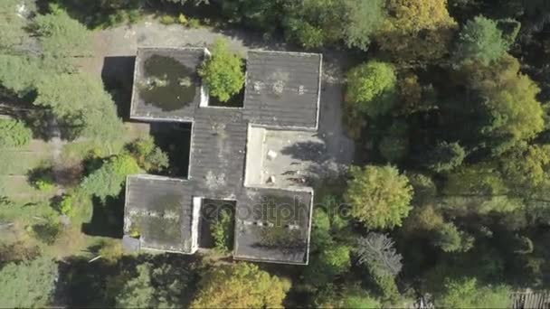 Flying over the the building in the middle of the forest. Aerial survey of the exterior of abandoned hospital.A lonely building view.The building was abandoned nearly twenty years ago, but never - Footage, Video
