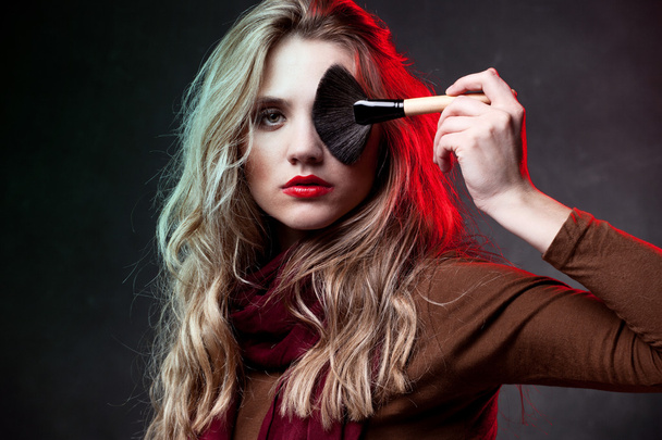 Portrait of beautiful woman with makeup brushes - Foto, Imagem