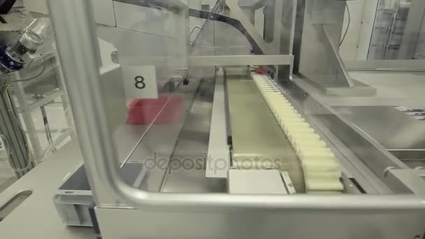 Pharmaceutics. Pharmaceutical worker operates tablet blister packaging machine. manufacture of syringes. syringe. pharmaceutical industry. Line machine conveyer for packaging glass bottles ampoules in - Footage, Video