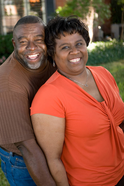 Mature African American couple laughing and hugging. - Foto, Bild