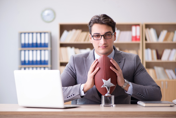 Homme d'affaires avec le football américain au bureau - Photo, image