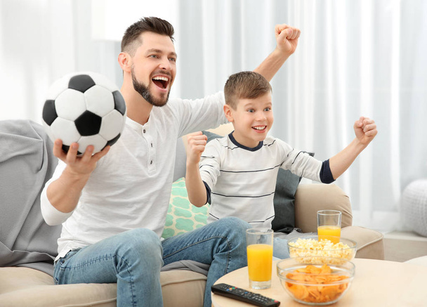 Father and son watching football - Фото, изображение