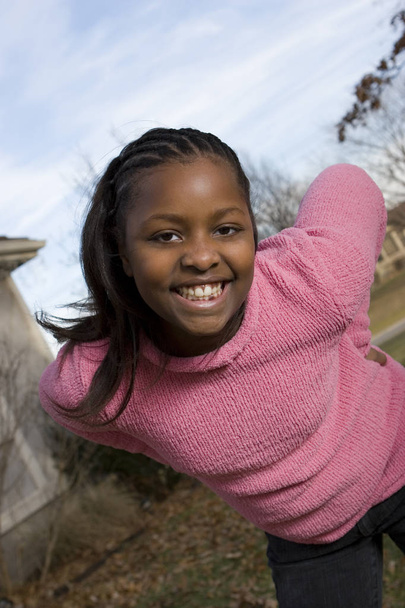 Happy African American young girl smiling outside. - Photo, image