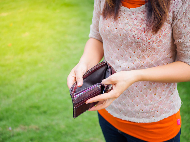 Unhappy bankrupt woman with empty wallet. - Photo, image
