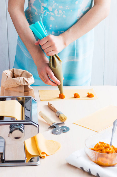 Woman making ravioli pumpkin blue cheese - Fotó, kép