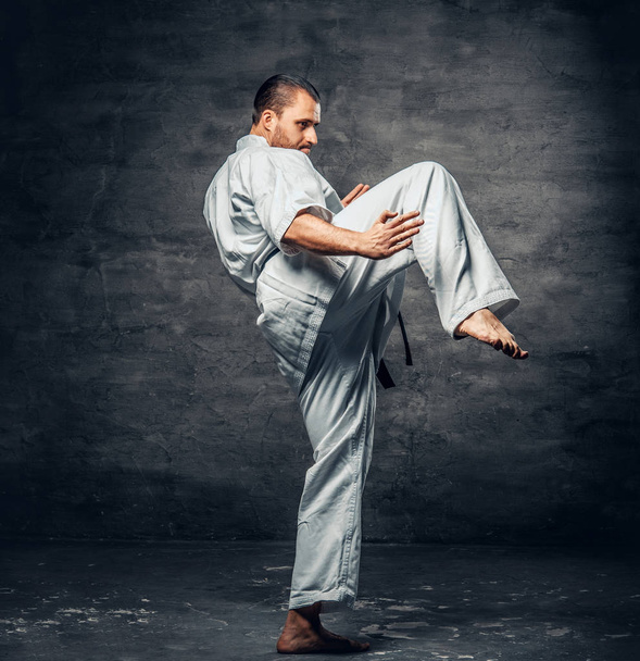Karate fighter dressed in a white kimono - Photo, Image