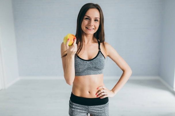 Fitness girl holding apple - Photo, image
