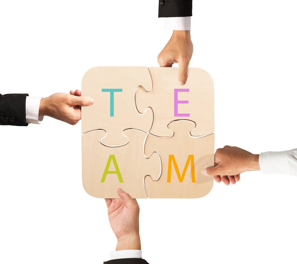team that works together with puzzle - Photo, Image