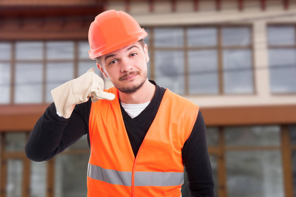 Handsome constructor showing call me hand sign - Φωτογραφία, εικόνα