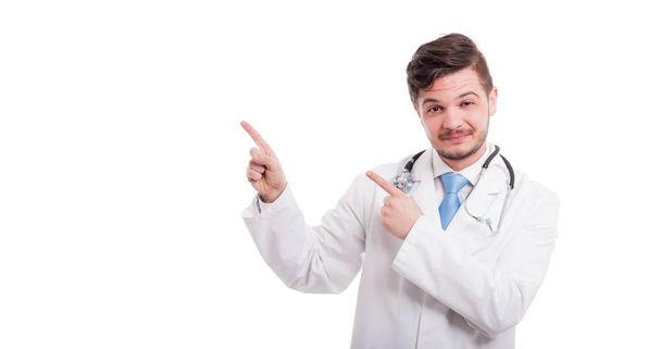 Portrait of happy male doctor pointing at copyspace - Photo, Image
