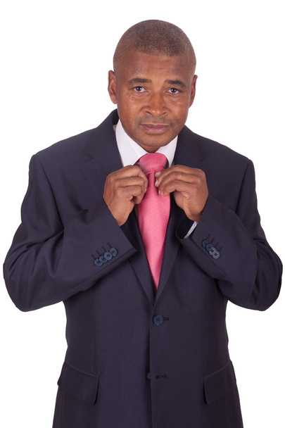 african businessman correcting a tie - Zdjęcie, obraz