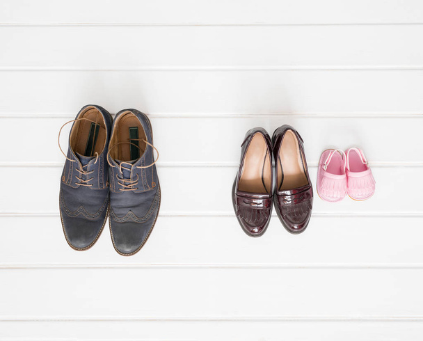 Males, females and children shoes setup on white background - Foto, imagen