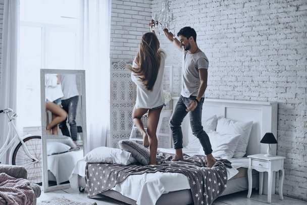 beautiful couple dancing on bed - Foto, Imagen