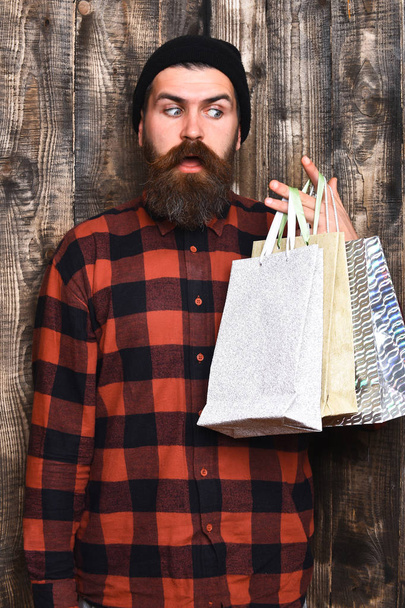 Bearded brutal caucasian hipster with moustache holding shopping packages - Fotografie, Obrázek