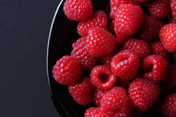 Studio image of raspberries over black background - Zdjęcie, obraz